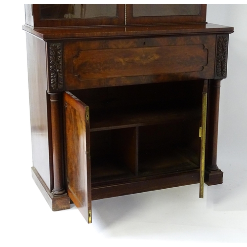 1558 - A late Georgian secretaire bookcase a carved scrolling pediment above two glazed doors. The long sec... 