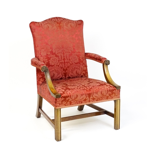 1559 - A 19thC upholstered Gainsborough armchair with carved floral decoration to the arms and raised on ch... 