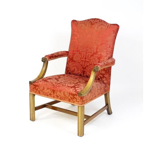 1559 - A 19thC upholstered Gainsborough armchair with carved floral decoration to the arms and raised on ch... 