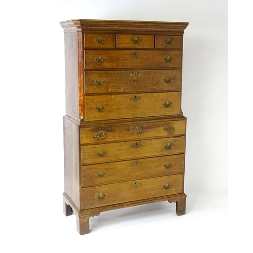 1566 - A late 18thC / early 19thC oak chest on chest with a moulded cornice above three short over seven lo... 