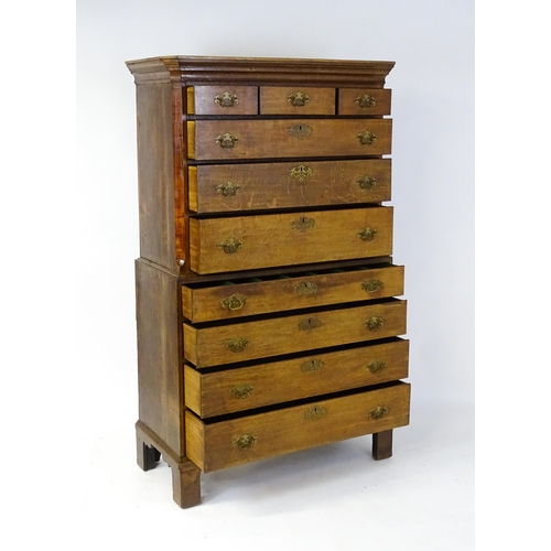 1566 - A late 18thC / early 19thC oak chest on chest with a moulded cornice above three short over seven lo... 