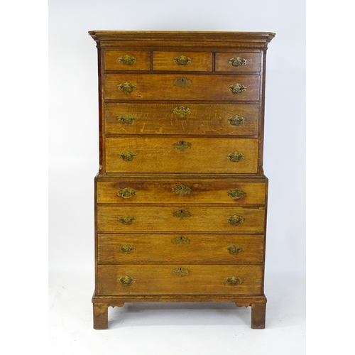 1566 - A late 18thC / early 19thC oak chest on chest with a moulded cornice above three short over seven lo... 