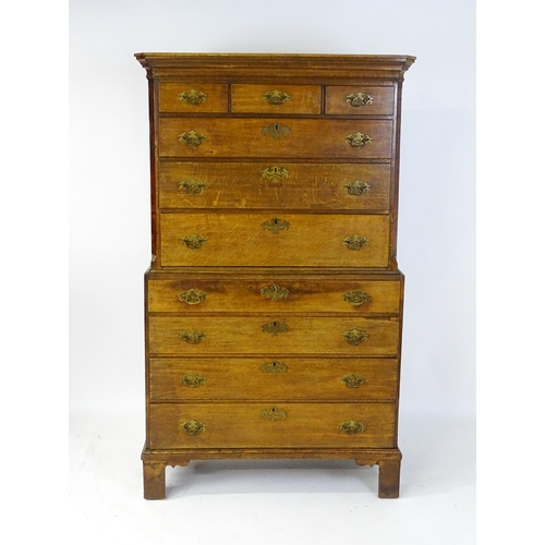 1566 - A late 18thC / early 19thC oak chest on chest with a moulded cornice above three short over seven lo... 