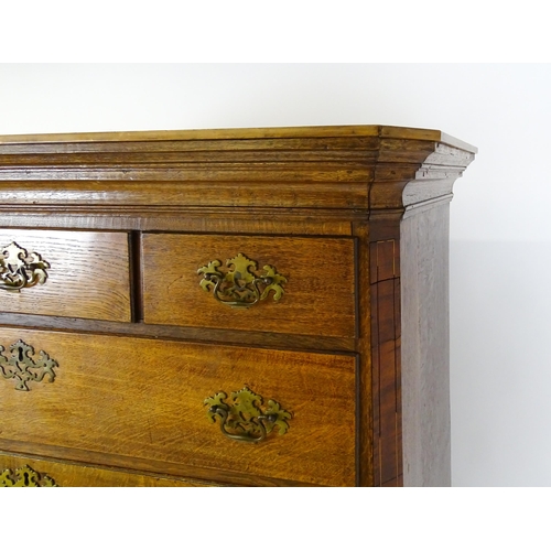 1566 - A late 18thC / early 19thC oak chest on chest with a moulded cornice above three short over seven lo... 