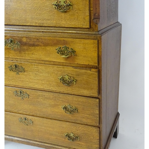 1566 - A late 18thC / early 19thC oak chest on chest with a moulded cornice above three short over seven lo... 