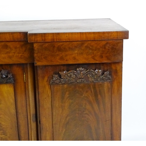 1567 - A Victorian mahogany sideboard with an inverted break front top, three frieze drawers and four panel... 