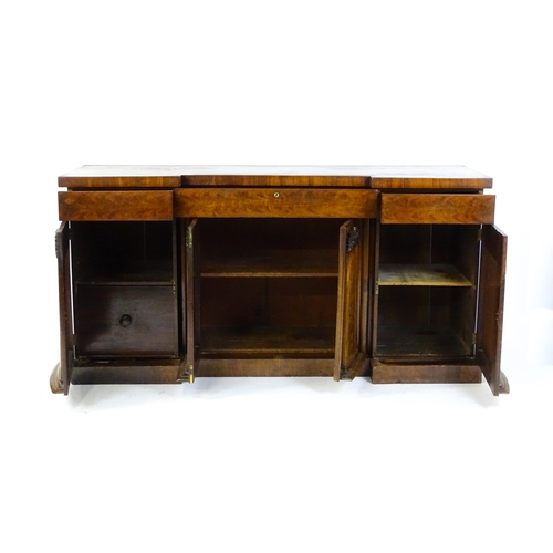 1567 - A Victorian mahogany sideboard with an inverted break front top, three frieze drawers and four panel... 