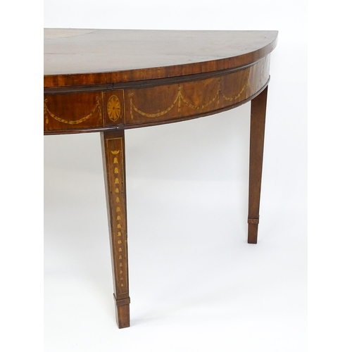 1573 - A large late 18thC mahogany serving table of demi lune form, having a marquetry inlaid top with sunb... 