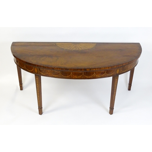 1573 - A large late 18thC mahogany serving table of demi lune form, having a marquetry inlaid top with sunb... 