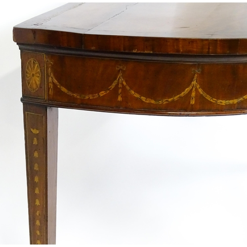 1573 - A large late 18thC mahogany serving table of demi lune form, having a marquetry inlaid top with sunb... 