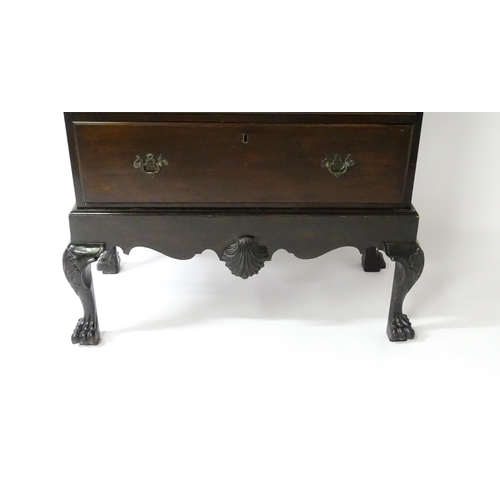 1587 - An 18thC and later mahogany chest on stand with a Greek Key moulded cornice above six graduated draw... 