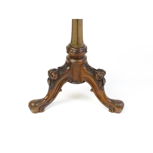 1589 - A Victorian mahogany wine table with a circular top above a turned, fluted pedestal and raised on th... 