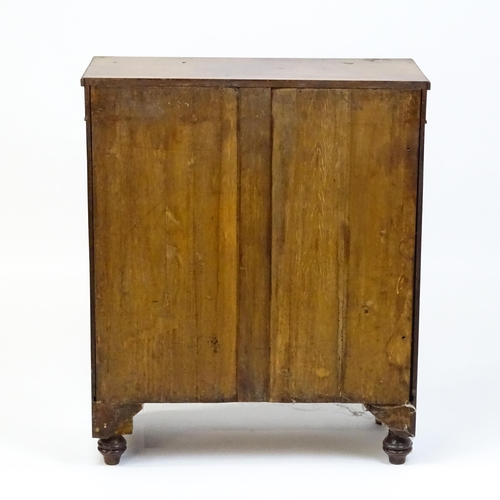 1599 - A 19thC mahogany cupboard with a rectangular top above two panelled doors flanked by turned tapering... 