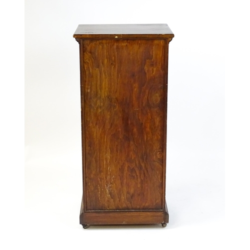 1618 - An early 20thC pine cabinet with a moulded top and panelled door concealing four shelves, the cabine... 