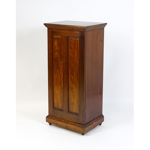 1618 - An early 20thC pine cabinet with a moulded top and panelled door concealing four shelves, the cabine... 