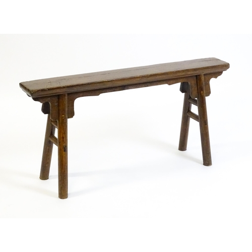 1645 - An early 19thC bench with shaped brackets to the apron and raised on four turned legs supported by m... 