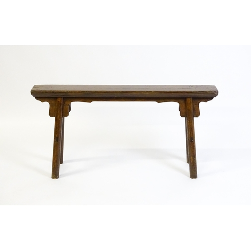 1645 - An early 19thC bench with shaped brackets to the apron and raised on four turned legs supported by m... 