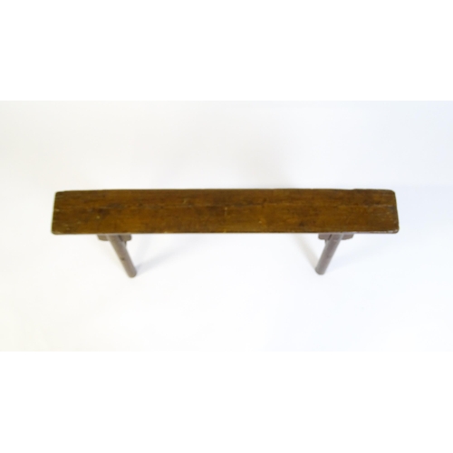 1645 - An early 19thC bench with shaped brackets to the apron and raised on four turned legs supported by m... 