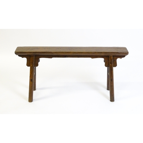 1645 - An early 19thC bench with shaped brackets to the apron and raised on four turned legs supported by m... 