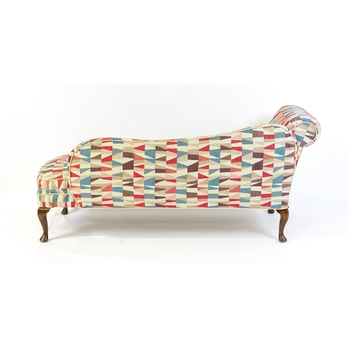 1694 - A mid 20thC chaise longue with a scrolled end and shaped backrest raised on four cabriole legs termi... 