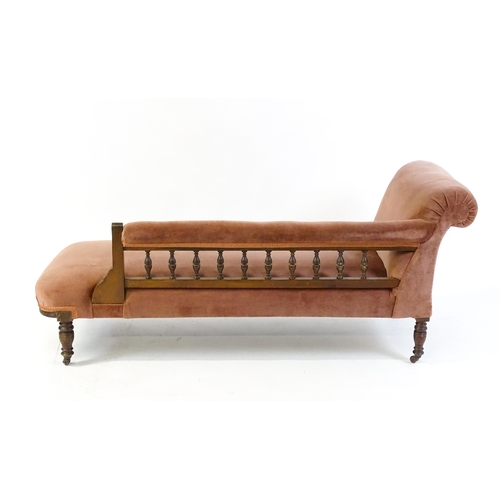 1695 - An early 20thC chaise longue with a scrolled end decorated with carved floral decoration and raised ... 