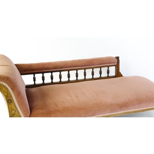 1695 - An early 20thC chaise longue with a scrolled end decorated with carved floral decoration and raised ... 