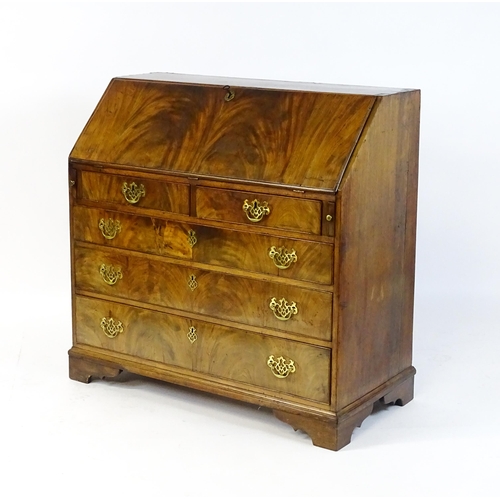 1707 - A late 18thC mahogany bureau with a fall front above two short over three long graduated drawers wit... 