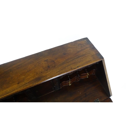 1707 - A late 18thC mahogany bureau with a fall front above two short over three long graduated drawers wit... 