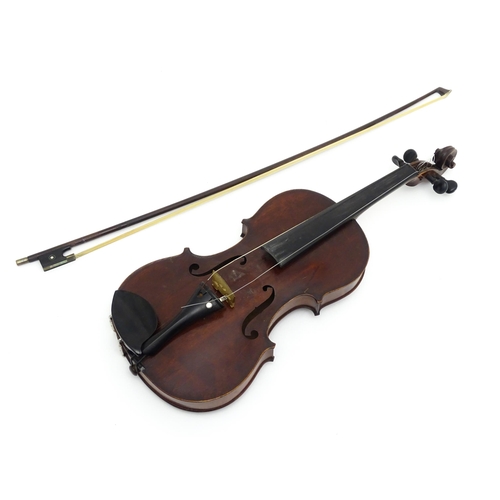 1373 - Musical Instrument: a cased early 20thC continental violin and bow, the interior bearing label 'Carl... 