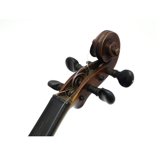 1373 - Musical Instrument: a cased early 20thC continental violin and bow, the interior bearing label 'Carl... 