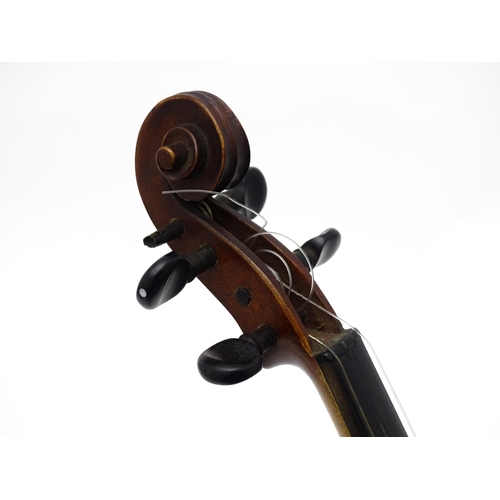 1373 - Musical Instrument: a cased early 20thC continental violin and bow, the interior bearing label 'Carl... 