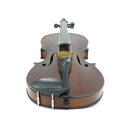 1373 - Musical Instrument: a cased early 20thC continental violin and bow, the interior bearing label 'Carl... 