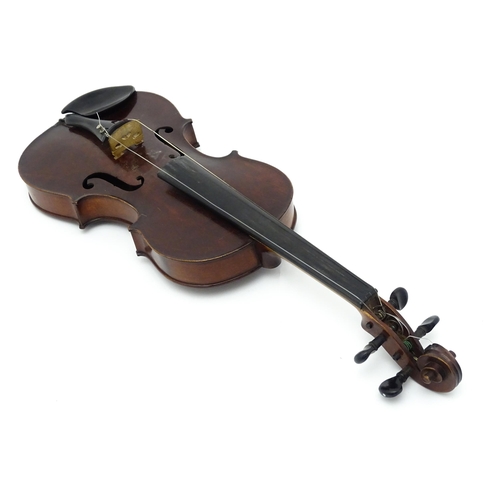 1373 - Musical Instrument: a cased early 20thC continental violin and bow, the interior bearing label 'Carl... 