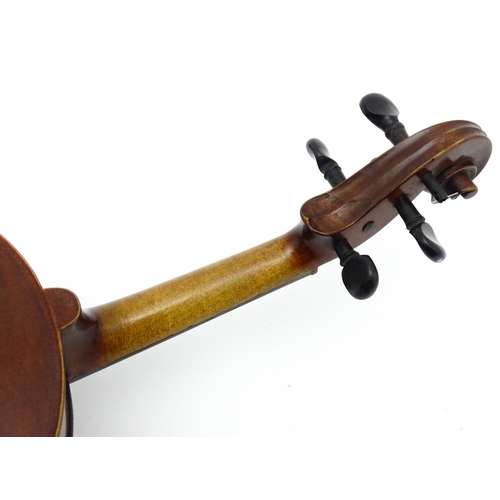 1373 - Musical Instrument: a cased early 20thC continental violin and bow, the interior bearing label 'Carl... 