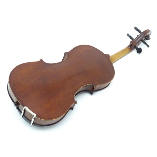 1373 - Musical Instrument: a cased early 20thC continental violin and bow, the interior bearing label 'Carl... 