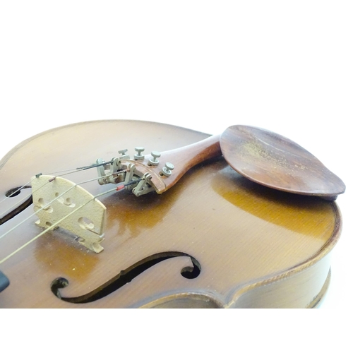 1374 - Musical Instrument: a cased late 20thC violin and bow, the interior bearing label 'Imported by Lesli... 