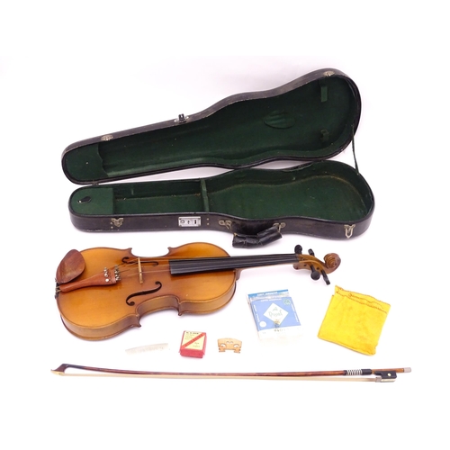 1374 - Musical Instrument: a cased late 20thC violin and bow, the interior bearing label 'Imported by Lesli... 