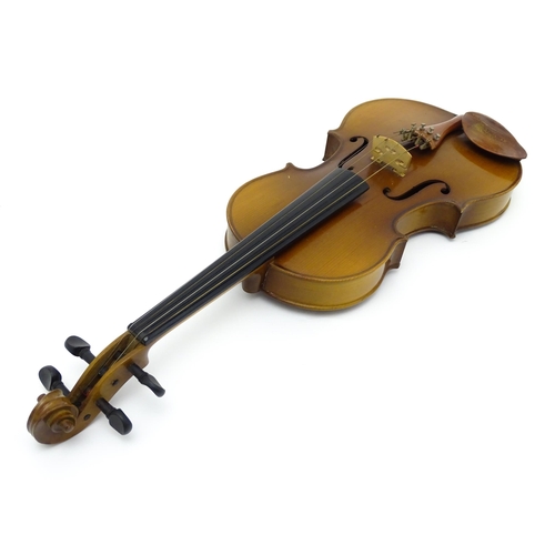 1374 - Musical Instrument: a cased late 20thC violin and bow, the interior bearing label 'Imported by Lesli... 