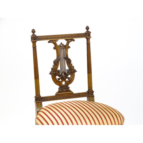 1696 - A pair of early 20thC lyre back side chairs with upholstered seats, on fluted legs. Approx. 32 1/2” ... 