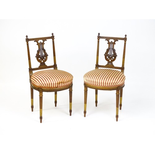 1696 - A pair of early 20thC lyre back side chairs with upholstered seats, on fluted legs. Approx. 32 1/2” ... 