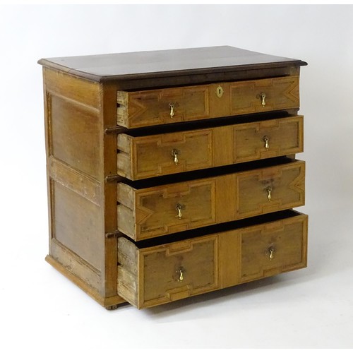 1697 - A late 17thC oak chest of drawers with a rectangular top above four graduated drawers with geometric... 