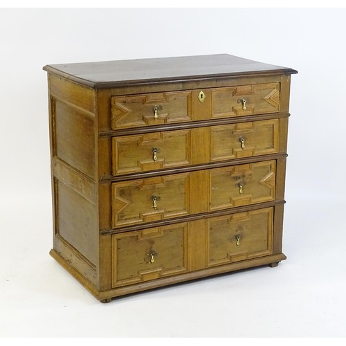 1697 - A late 17thC oak chest of drawers with a rectangular top above four graduated drawers with geometric... 