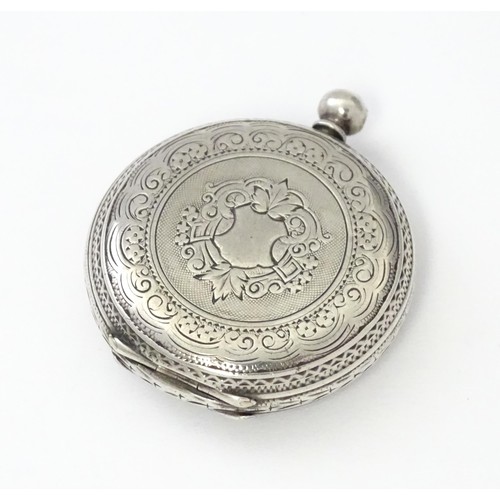 760 - A white metal cased fob watch, the white enamel dial having Roman numerals. Together with a watch ke... 