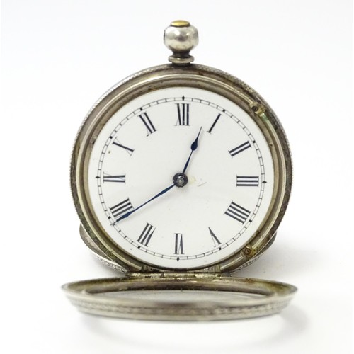 760 - A white metal cased fob watch, the white enamel dial having Roman numerals. Together with a watch ke... 