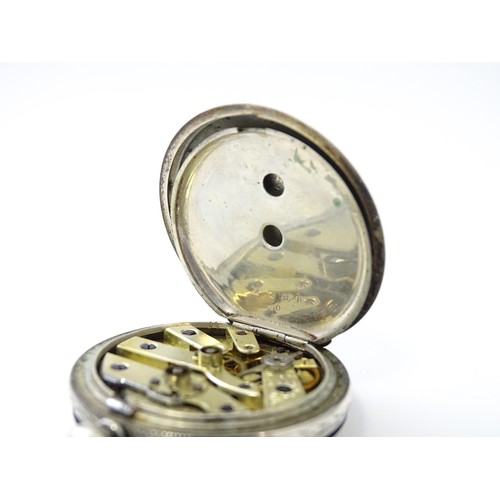 760 - A white metal cased fob watch, the white enamel dial having Roman numerals. Together with a watch ke... 