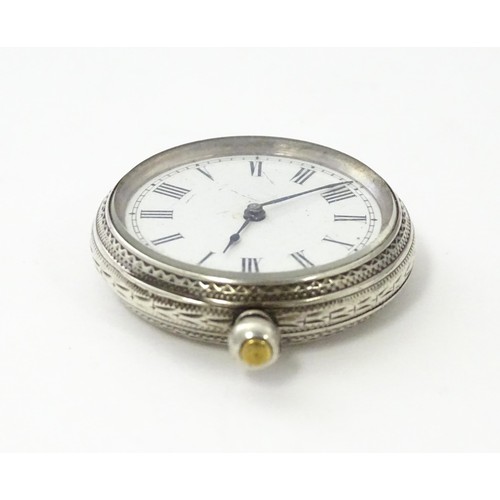 760 - A white metal cased fob watch, the white enamel dial having Roman numerals. Together with a watch ke... 