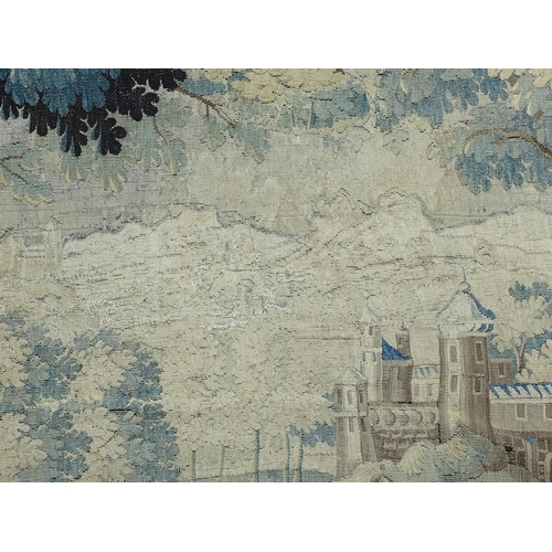 1383 - A late 17th / early 18thC Brussels tapestry depicting a pastoral tree lined landscape with castle by... 