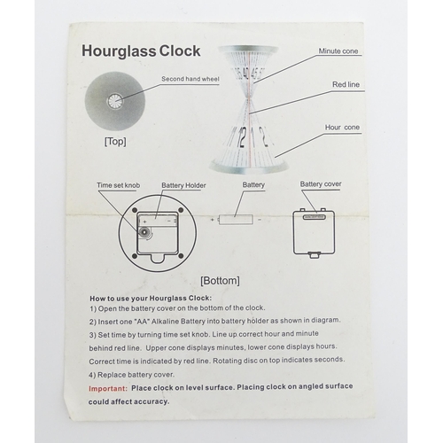 1498 - A late 20thC hourglass clock. Together with a time cube. Largest approx. 7