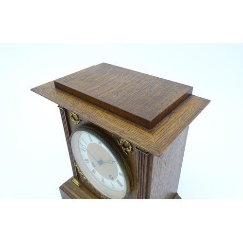 1504 - A German oak cased 8 day mantel clock, the movement marked Lenzkirch and striking on a gong. Approx.... 