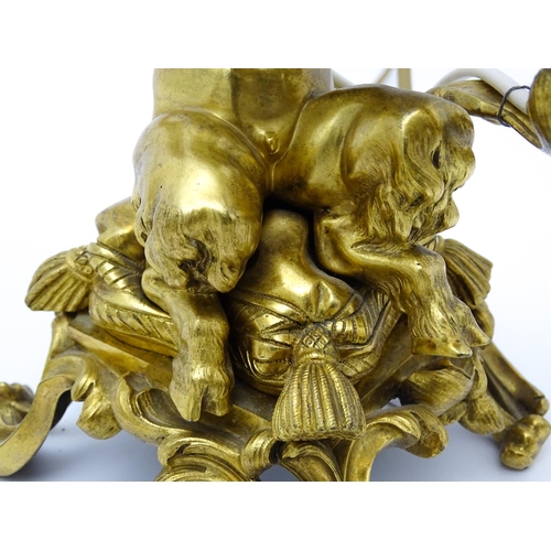 1532 - A pair of Continental gilt bronze twin branch table lamps, each modelled as a seated faun playing a ... 